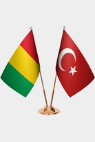 Guinea and Türkiye dual desk flag set with gold pedestal, satin office table flag