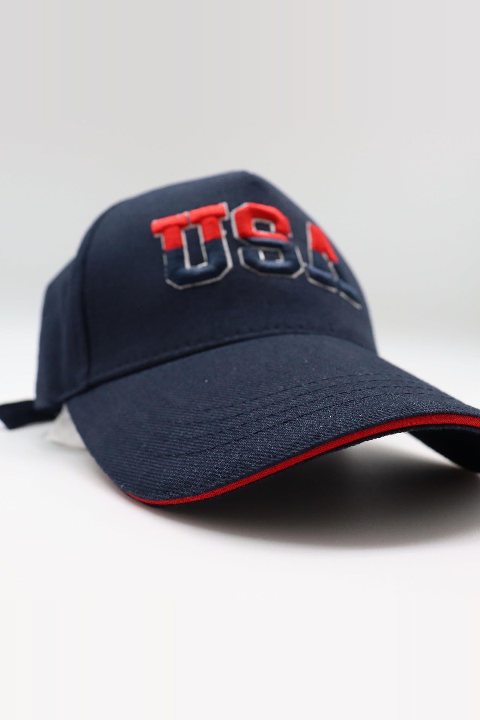 Front view of the navy USA cap with red sandwich trim
