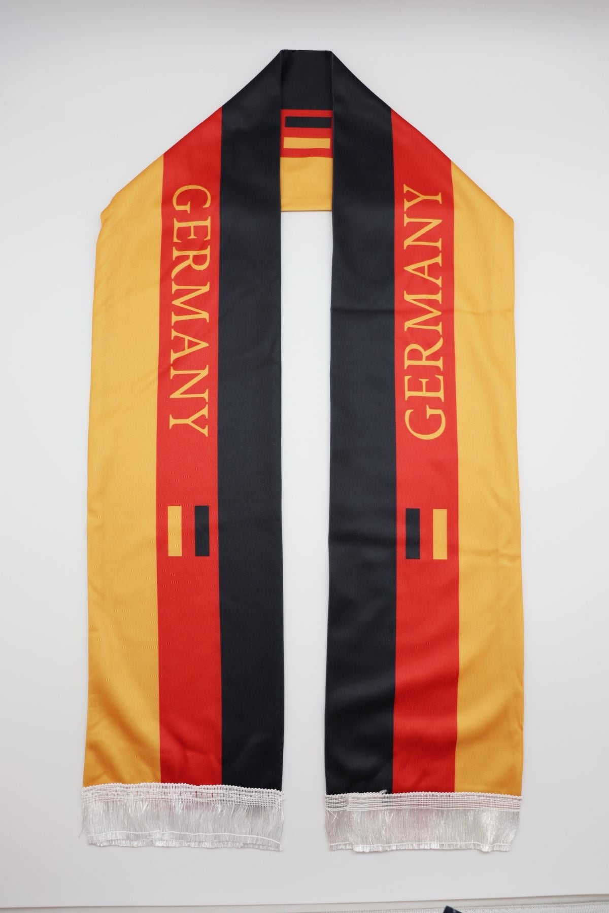 Germany Flag Satin Soccer Scarf laid flat, full length with GERMANY lettering and white fringes