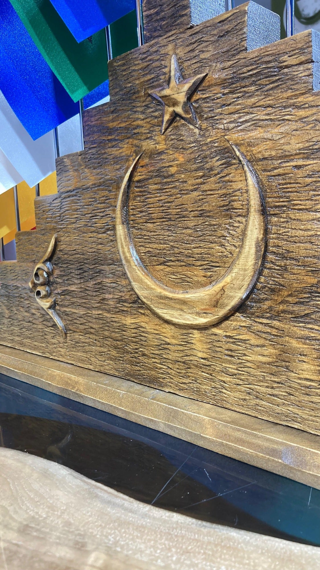 Close-up of the hand-carved crescent and star on the pine base